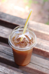 Bumble coffee. Coffee with juice in a disposable plastic cup with a straw. Coffee with orange...