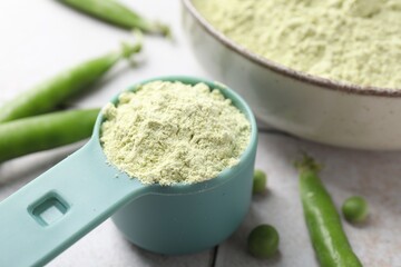 Protein powder and green peas on light table, closeup