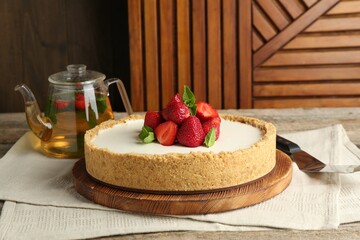 Tasty cheesecake with strawberries and mint on wooden table, closeup