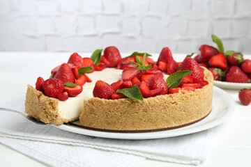 Delicious cheesecake with strawberries and mint on white table, closeup
