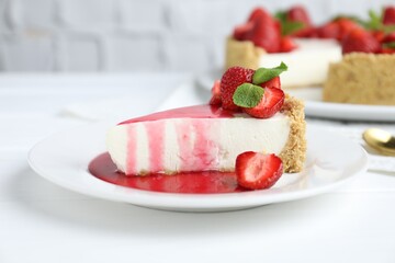Piece of tasty cheesecake with strawberries, sauce and mint on white wooden table, closeup