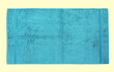 Blue beach towel on beige background, top view