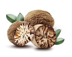Nutmeg seeds with green leaves on white background. Aromatic spice