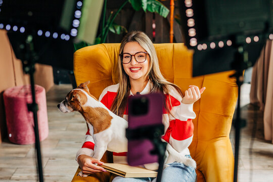 Video blogger with dog recording at home