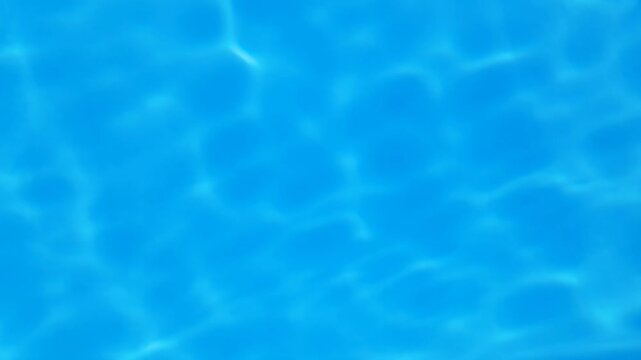 Background and texture with top view of blue, clear, clean water in the pool
