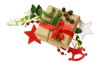 Christmas gift box with ribbon bow, fir-tree twig and small cones in a corner holiday arrangement with snowberries and decorations isolated on white or transparent background