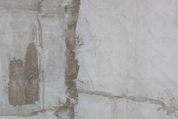 Rough plaster wall repair in urban outdoor setting