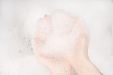 Female hands in foam close-up. girl's hands in soap foam. washing, cleaning, washing dishes