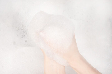 Female hands in foam close-up. girl's hands in soap foam. washing, cleaning, washing dishes