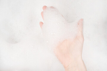 Female hands in foam close-up. girl's hands in soap foam. washing, cleaning, washing dishes