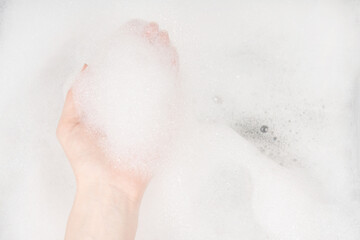 Female hands in foam close-up. girl's hands in soap foam. washing, cleaning, washing dishes
