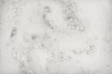White pure foam in water background texture. dishwashing foam close up