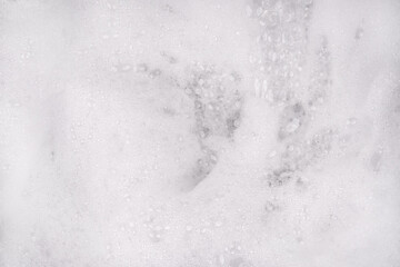 White pure foam in water background texture. dishwashing foam close up