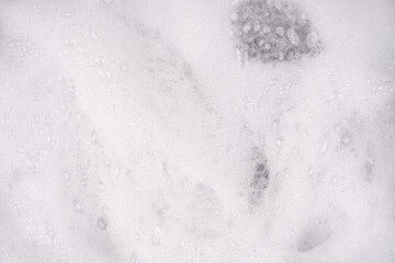 White pure foam in water background texture. dishwashing foam close up