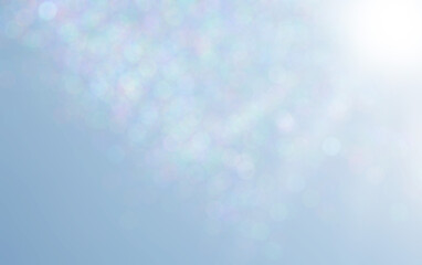 Colorful bokeh blur and white sunlight on light blue background