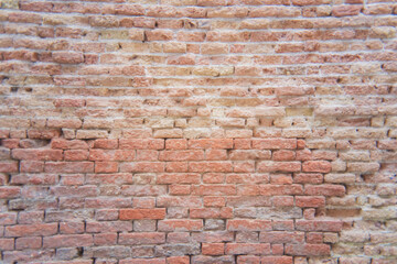 Rustic brick wall with faded colors and vintage texture in urban setting