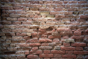 Obraz premium Textures of time revealed in a weathered brick wall from a vintage perspective