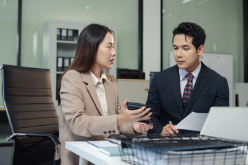 Business consultants discuss tax, merger strategy and restructuring in modern office.