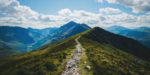 A scenic mountain ridge with a rocky trail under a blue sky filled with fluffy clouds.