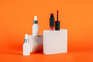 Mockup of black blank thin tube - mascara, lip gloss, gel, eyeliner, oil, etc. Cosmetic package with stylish props on orange background.