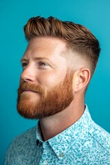 Obraz premium Fashionable men's slick back with fade haircut - midlife white man with red hair. Visual idea of style for aging men. A chic and vibrant male with effortless elegance. Blue solid background.