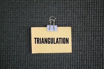 Paper with the word triangulation. the tracing and measurement of a series or network of triangles...