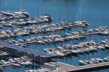 Moored Yachts and Sailboats in Alicante Marina with Solar Roof Dock and Calm Blue Waters on a...