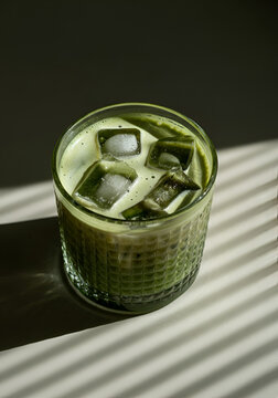 Top of view of a textured glass of iced matcha latte.