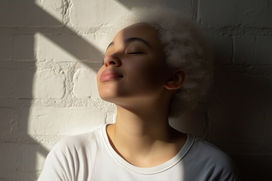 Radiant Soul in Sunlight: A young woman closes her eyes, basking in the soft embrace of natural light, feeling the warmth, peace, and serenity.