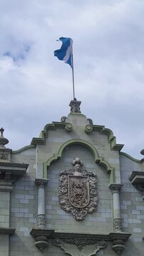 Vertical View, County Flag of Guatemala Waving on National Palace of Culture Building in City Downtown