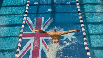 Top view of a butterfly stroke over the Australian flag at the pool bottom. Powerful movement and national pride in elite sports. Concept of athlete lifestyle, fitness and determination theme