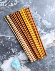 Aesthetic arrangement of incense sticks on a bright marble surface with ambient hues