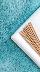 Neat arrangement of towel and toothbrush on a plush surface with oceanic hues for relaxation