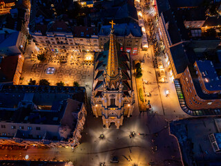Novi Sad, Serbia - June 26, 2025: Night Aerial view of the square Freedom "Trg Slobode" and Catholic Church of the Name of Mary in the Old Town, Novi Sad.