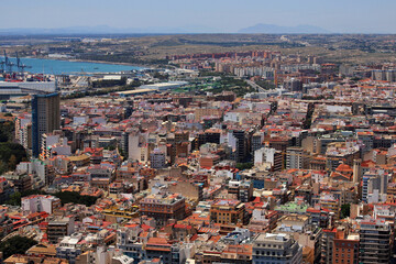 Obraz premium Panoramic View of Alicante City with Harbour, Colorful Rooftops and Mediterranean Urban Landscape on a Bright Summer Day