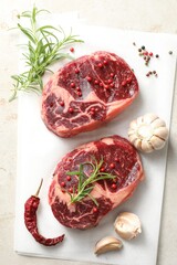 Pieces of raw beef meat and spices on table, flat lay