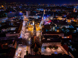 Novi Sad, Serbia - June 26, 2025: Night Aerial view of the square Freedom "Trg Slobode" and Catholic Church of the Name of Mary in the Old Town, Novi Sad.