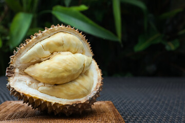 Fresh ripe durian on wicker table outdoors, space for text