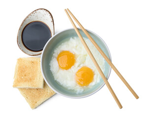 Half-boiled eggs in bowl, soy sauce, toasts and chopsticks isolated on white, top view. Traditional...