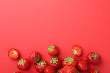 Fresh ripe strawberries on red background, flat lay. Space for text