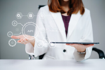 Woman presents holographic API dashboard using tablet. Concept of coding, integration, data, UX,...