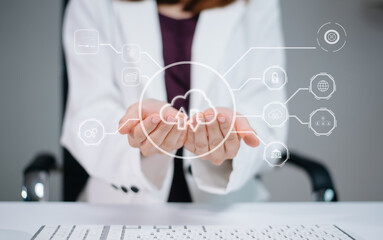 Woman holding virtual cloud network with futuristic icons for data, storage, and cybersecurity.
