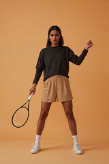 Female tennis player in studio