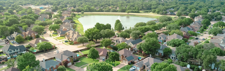 Fototapeta premium Panorama aerial view upscale waterfront residential properties suburbs Dallas Fort Worth metroplex, Rheudasil Park two-story homes, cul-de-sac streets, large backyards, swimming pools, trees