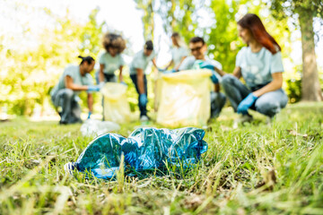 Group of volunteer cleaning picking up plastic litter in the park - Diverse group of people collect trash in the forest - Environmental protection, non profits organization and save the planet concept