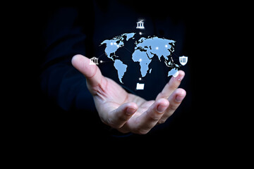 Businessman holding a glowing digital world map with financial and security icons in his hand