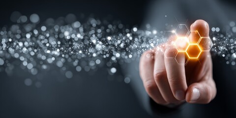 Hand touching glowing hexagonal interface with digital particles, representing futuristic technology and innovation
