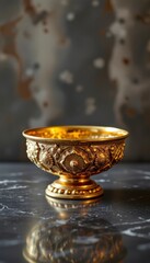 Ornate Golden Bowl on Dark Marble Surface