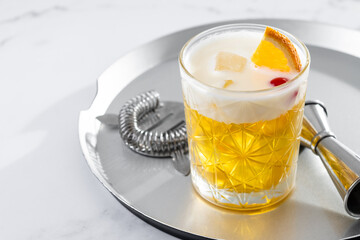 Classic cocktail whiskey sour on white marble background. Copy space