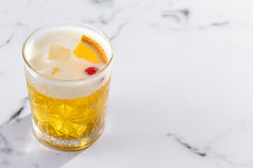 Classic cocktail whiskey sour on white marble background. Copy space